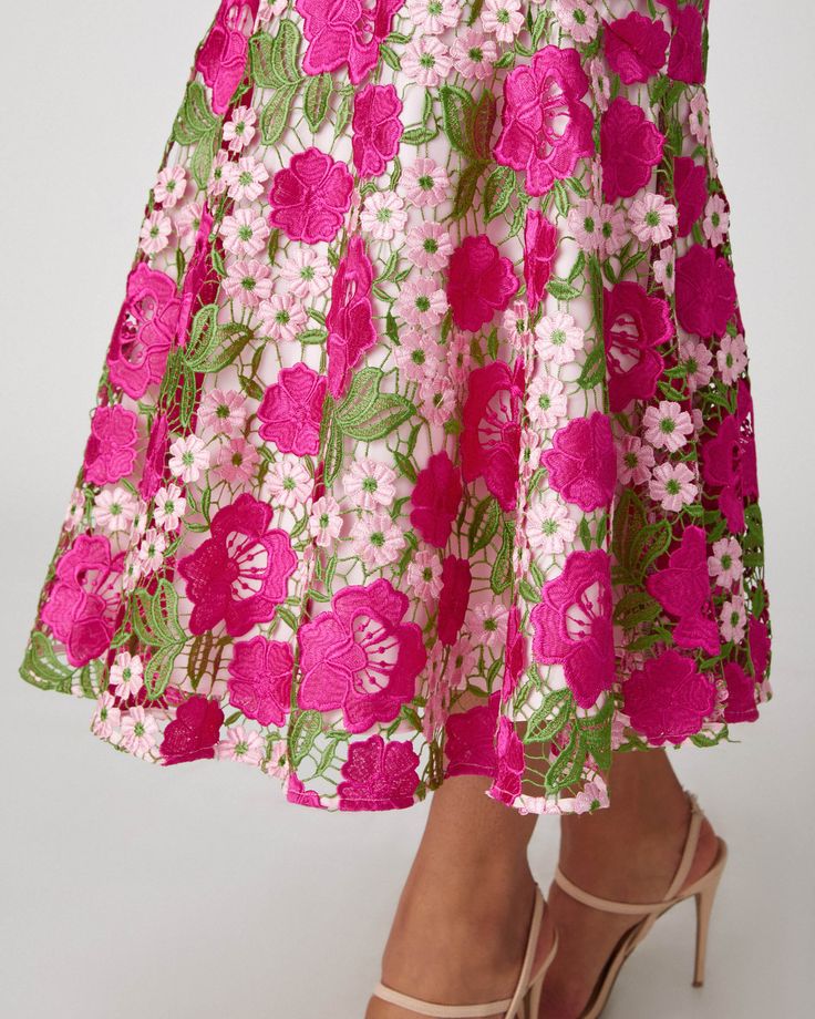 Beautiful, multi-color floral lace midi dress. Style features a round neckline and a short sleeve with a scalloped edge. Form fitted silhouette with skirt bottom flounce. Shoulder yoke and sleeves unlined. The body is lined. Hidden back zipper. Color: Fuchsia/Green Multi 100% Polyester. Dry clean only. Party Dress With Scalloped Edges And Short Sleeves, Short Sleeve Lace Dress With Scalloped Edges, Lace Dress With Scalloped Edges And Short Sleeves, Spring Midi Dress With Scalloped Edges, Multicolor Lace Dress For Garden Party, Pink Scalloped Lace Dress For Garden Party, Feminine Lace Dress With Scalloped Edges, Floral Print Midi Lace Dress For Garden Party, Floral Print Lace Midi Dress