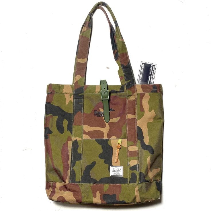 "Herschel \"Der Bomber Der Herzen\" Ltd edition military style camo canvas tote bag, as new, never been used. Width 35 cm Height 45 with handle Depth. 12 cm filled" Military Style Rectangular Bag For Everyday Use, Military Style Satchel Bag For Daily Use, Military Style Satchel Bag For Everyday Use, Military Style Satchel For Everyday Use, Military Style Bags With Pockets For Everyday Use, Military Style Everyday Bag With Pockets, Military Style Canvas Satchel Bag, Camouflage Travel Bag With Adjustable Strap, Military Style Shoulder Bag For Everyday Use