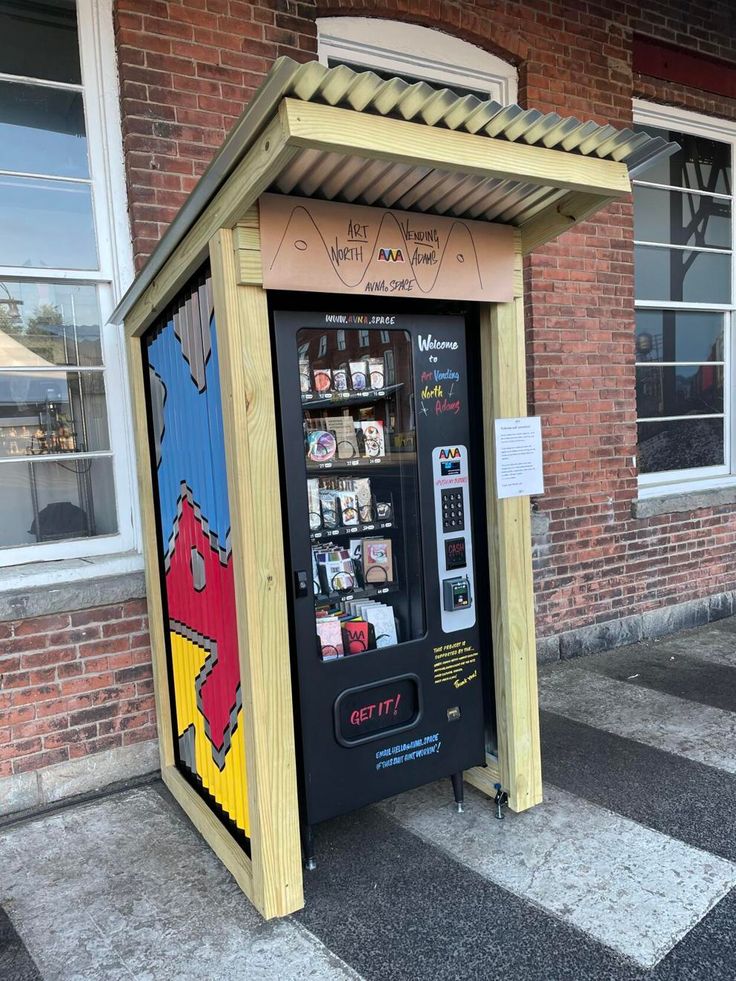 an atm machine sitting in front of a brick building