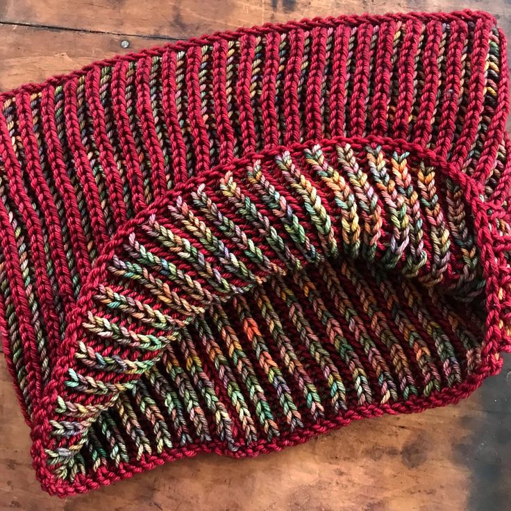 a knitted hat sitting on top of a wooden table