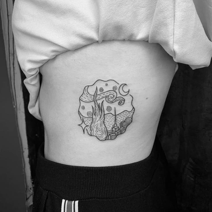 a black and white photo of a woman's thigh with a tattoo on it