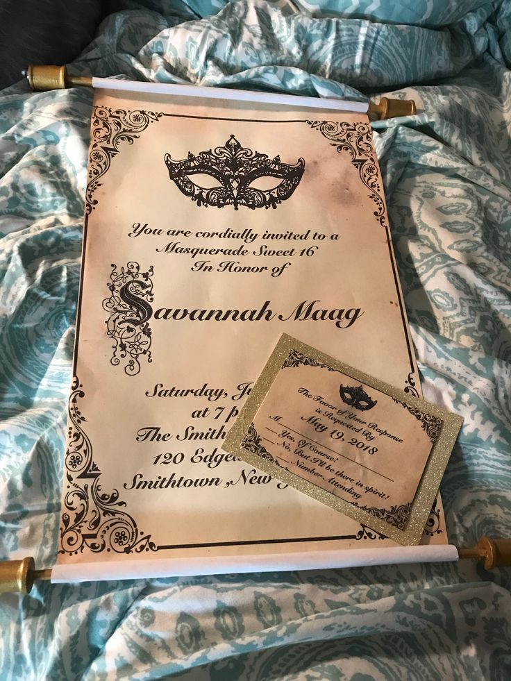 a certificate is laying on a bed with blue sheets and gold trim around the edges