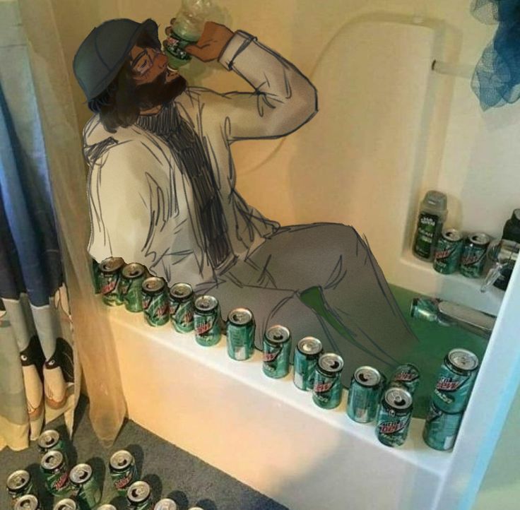 a man sitting in a bathtub filled with cans of beer and drinking from a cup