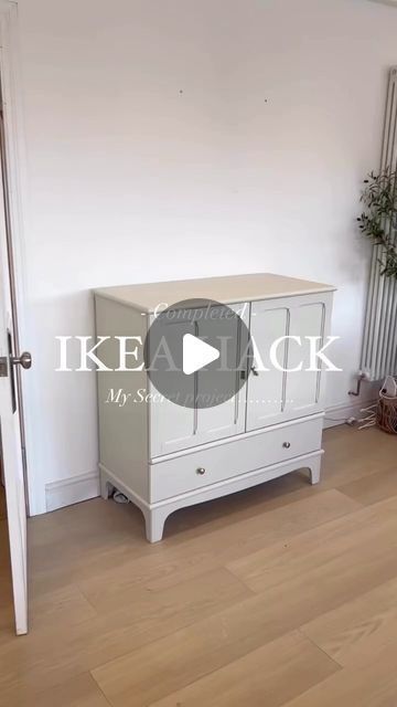 a white cabinet sitting in the corner of a room