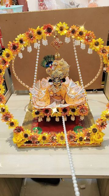 an idol with sunflowers around it on a table