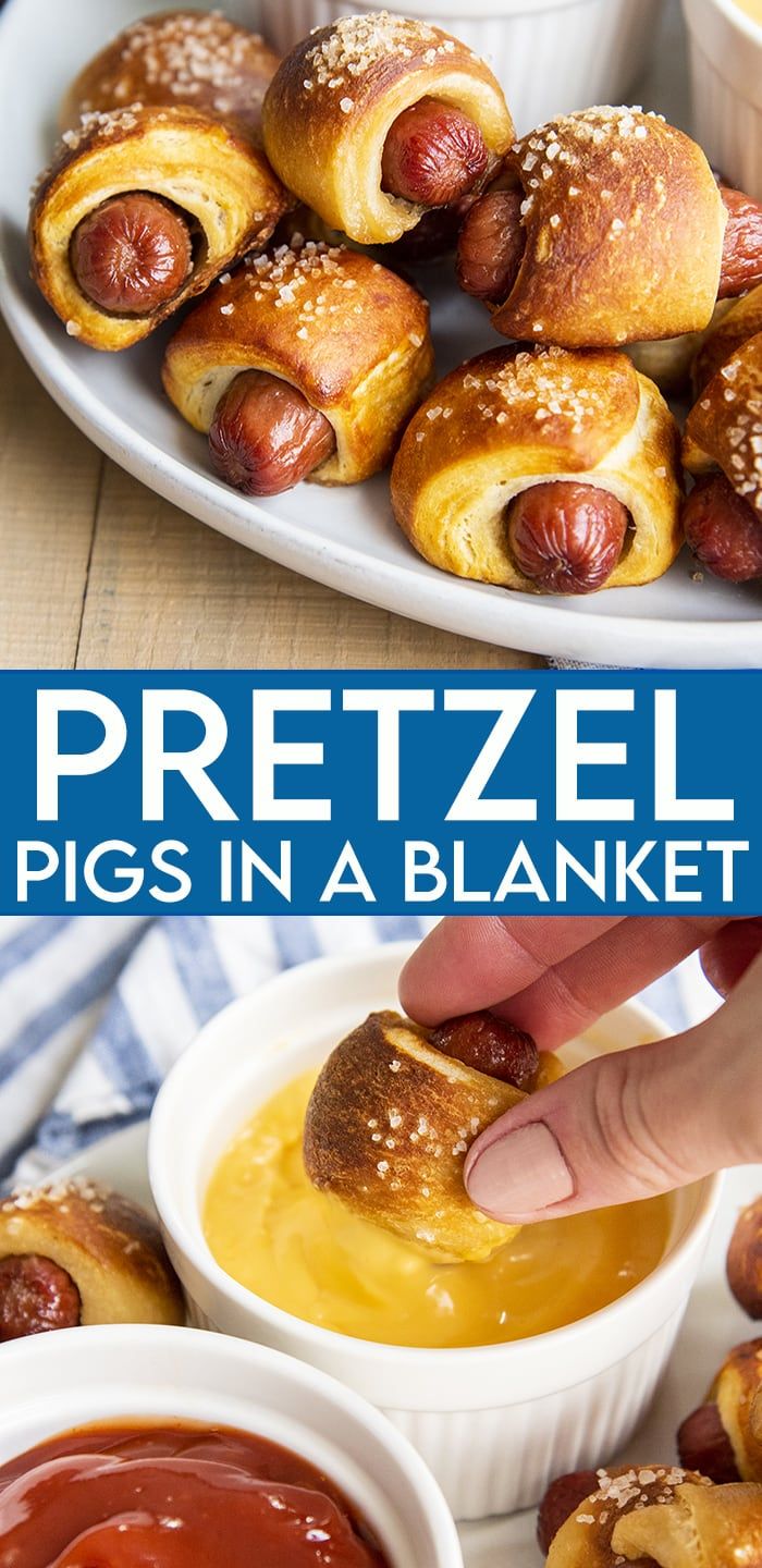 the pretzel pigs in a blanket is being dipped with ketchup and mustard