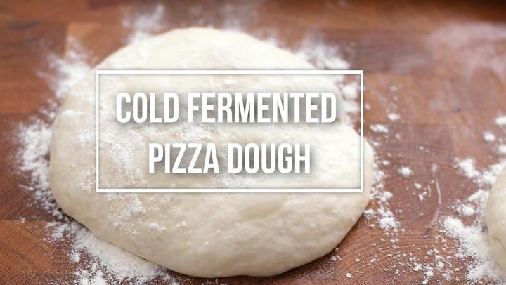 two uncooked pizza doughs sitting on top of a wooden cutting board with the words cold fermented pizza dough