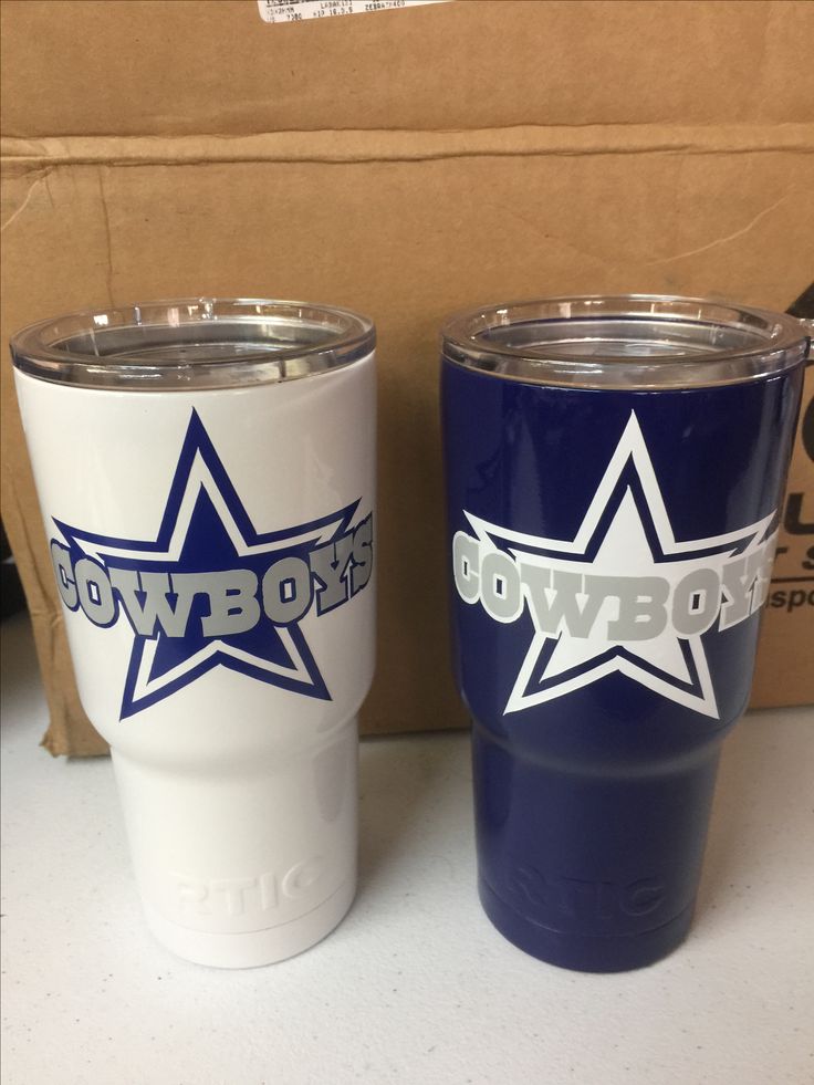 two blue and white tumblers sitting next to each other on top of a table