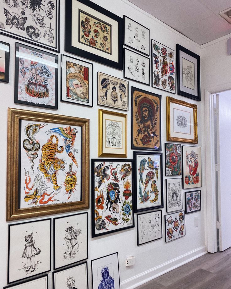 a wall covered in lots of different types of tattoos and framed pictures on the wall