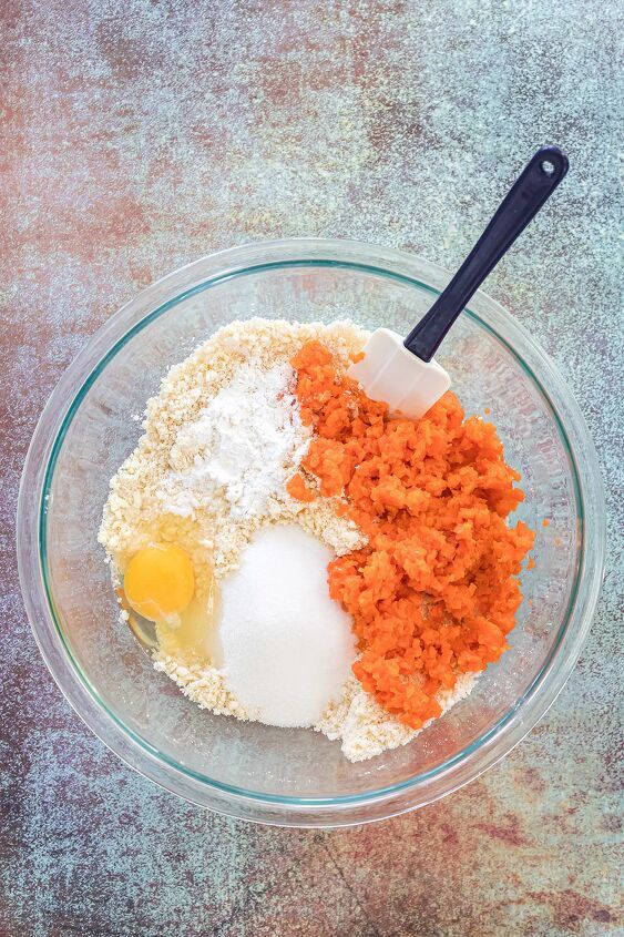 the ingredients for carrot cake in a glass bowl