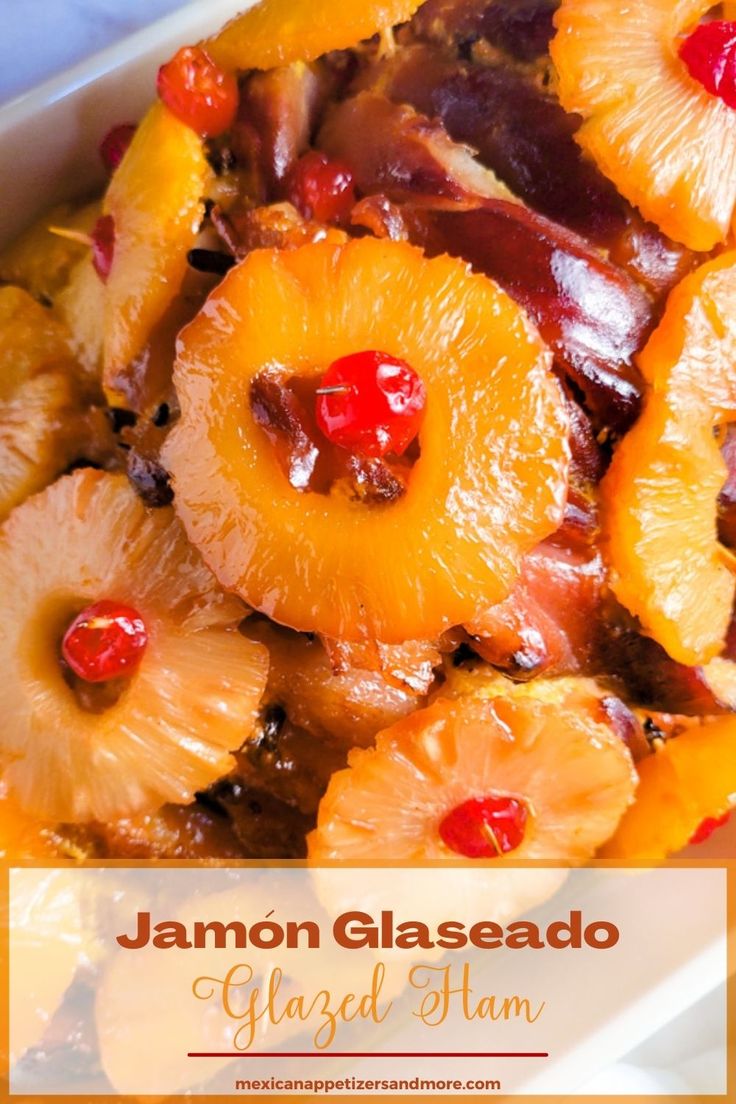 a close up of food with pineapples and cherries on it in a dish