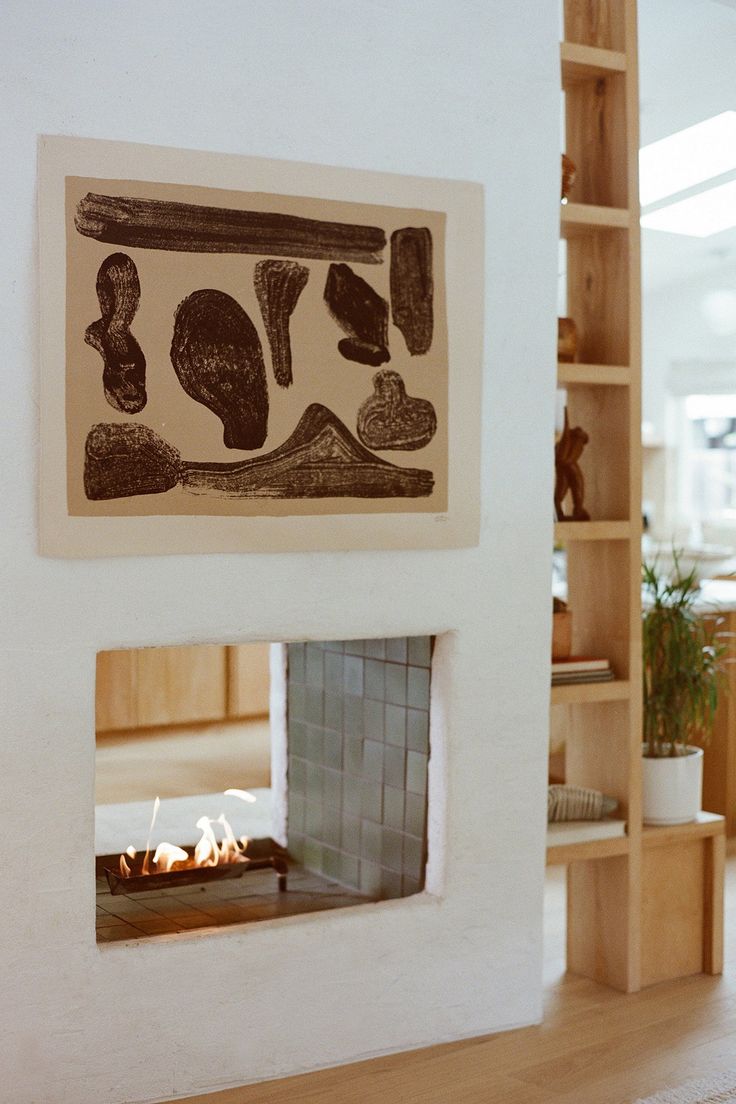 a fireplace in a living room next to a book shelf with books on the shelves