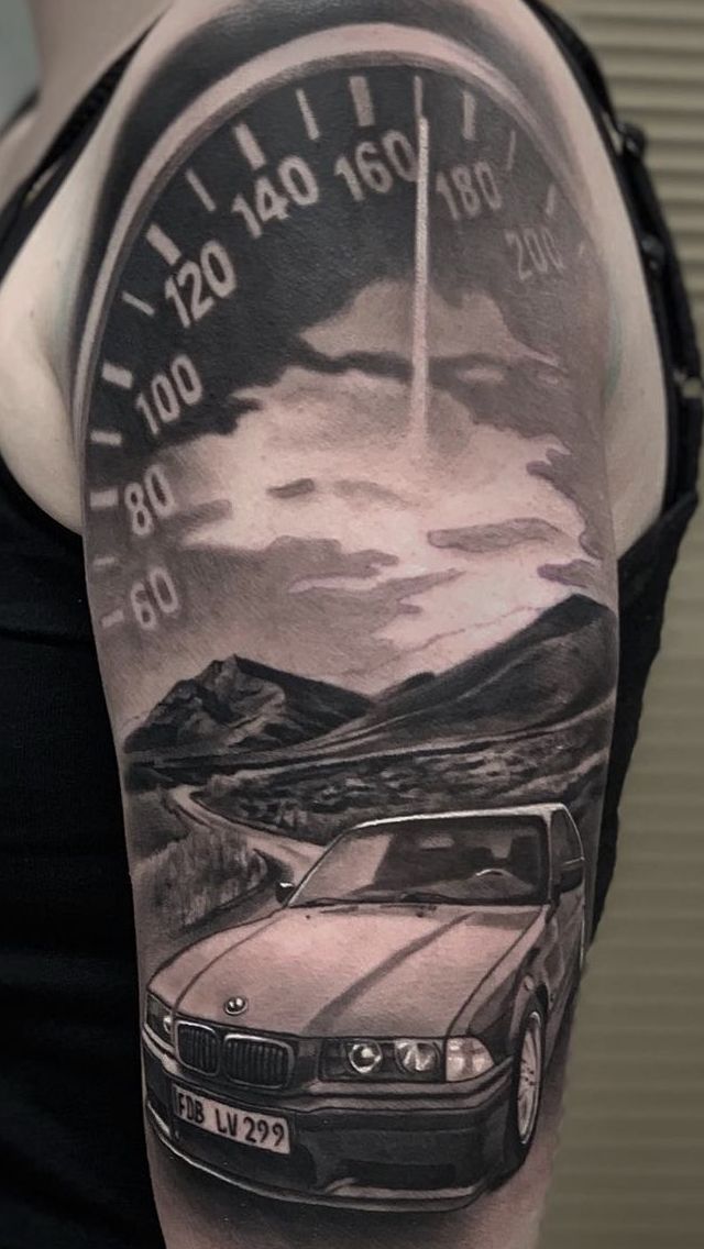 a woman's arm with a car and speedometer tattoo on it