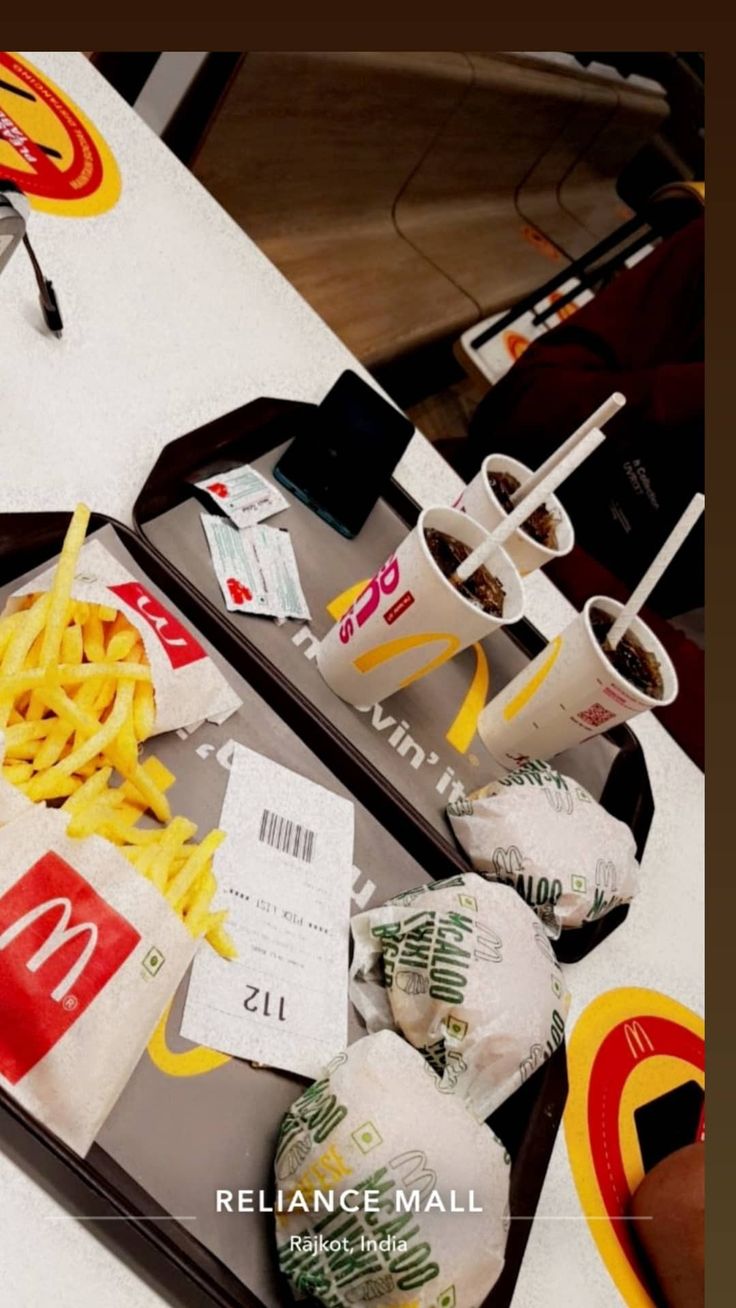 an open suitcase with fries and mcdonald's on the table in front of it