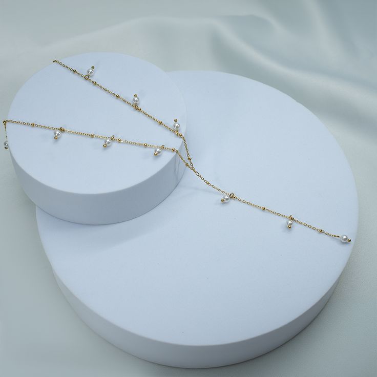 add a subtle touch to your look with our Sun Is Shining Lariat Necklace. expertly crafted for a soft and elegant look, this necklace is the perfect accessory when you want to make a delicate statement. 18k gold pvd over 316L stainless steel 4mm glass pearls water & tarnish resistant 15.5" long + 2" extender 3.5" long drop Sun Is Shining, Lariat Necklace, 18k Gold, Sun, Stainless Steel, Glass, Water, Gold