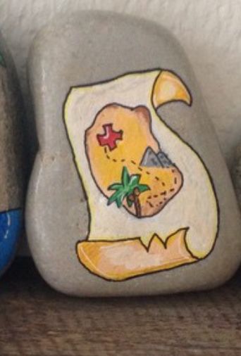 two rocks with designs painted on them sitting next to each other, one is blue and the other is yellow