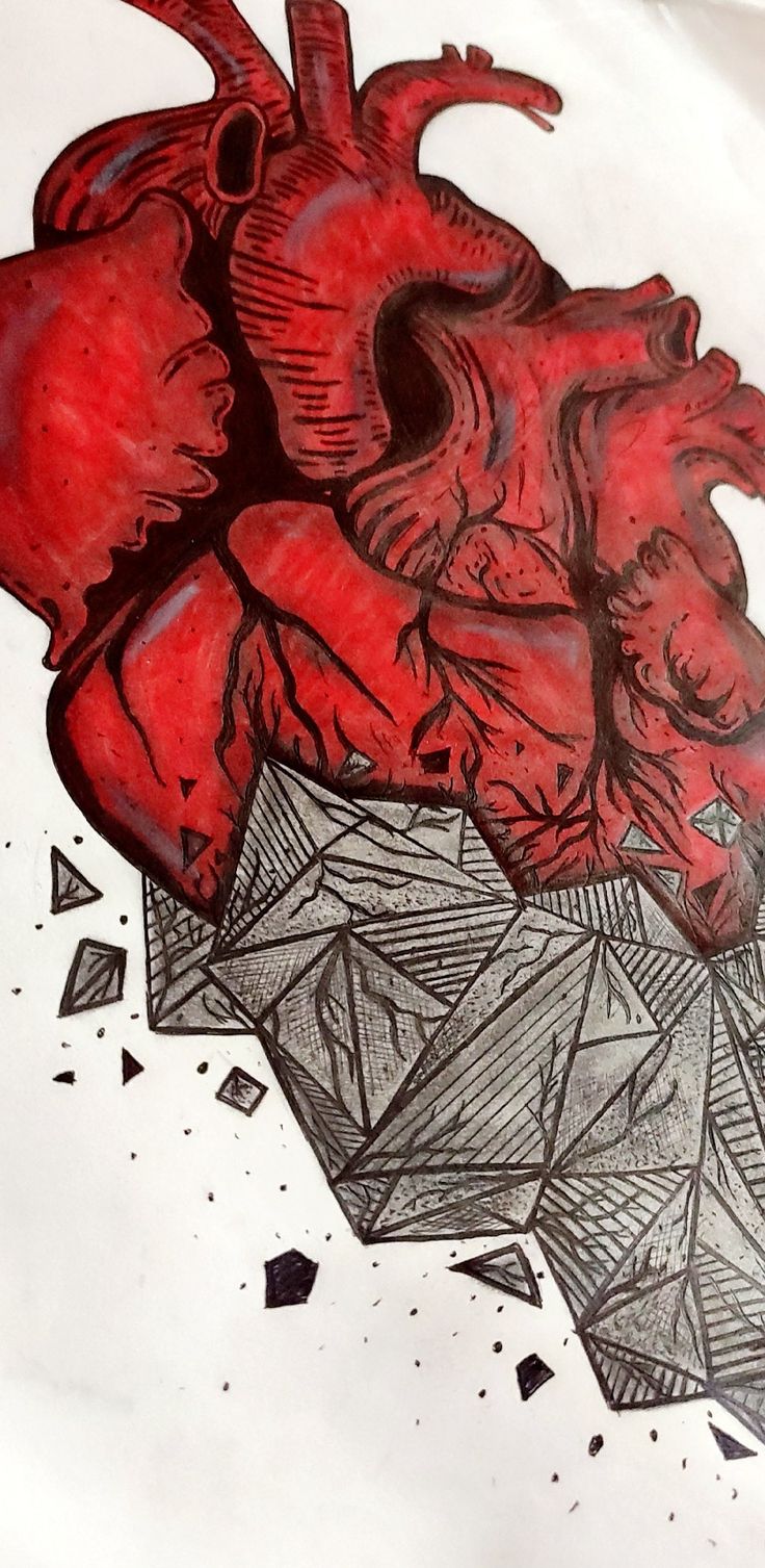 a drawing of a human heart on top of a piece of paper with shattered triangles around it