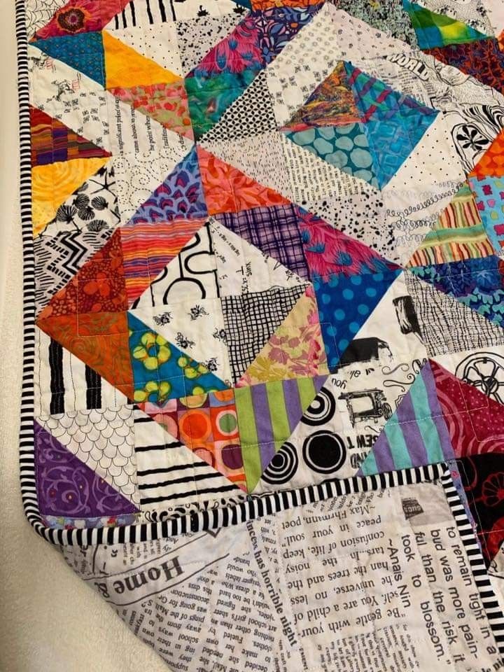 a close up of a colorful quilt on a table