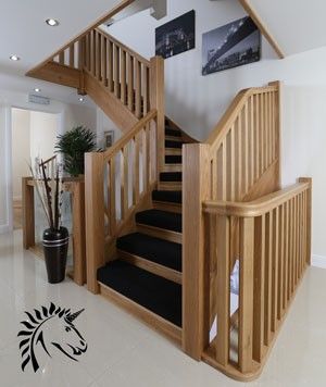 there is a staircase in the house with black carpet on the floor and white walls