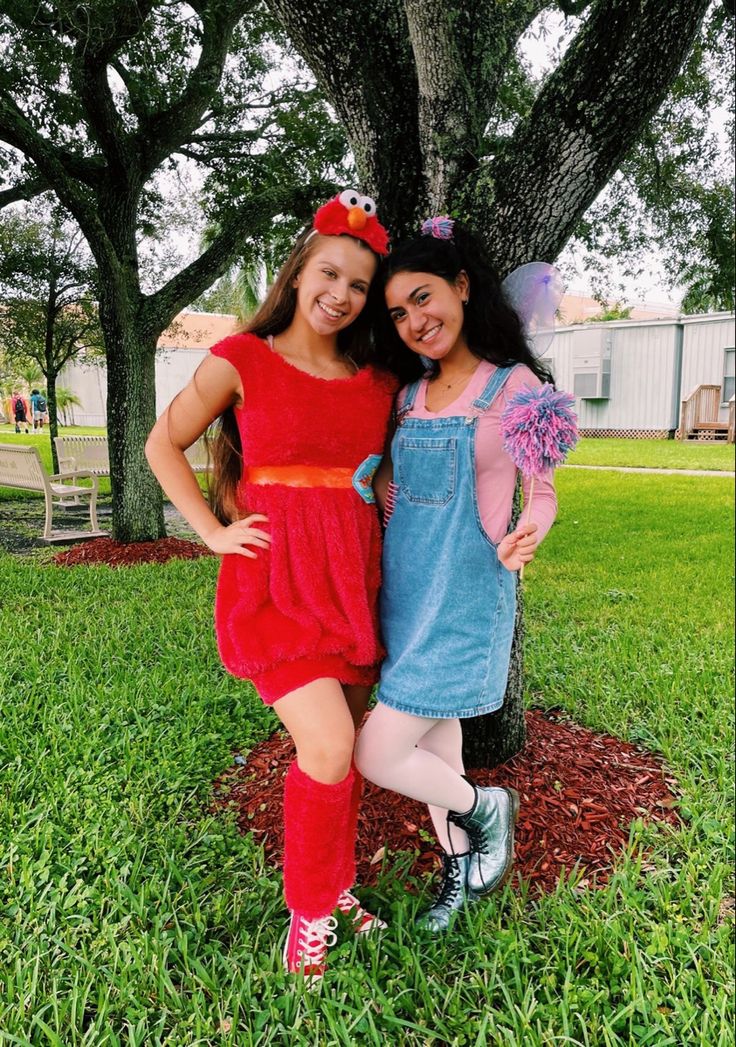 two girls dressed up in costumes posing for the camera with their arms around each other