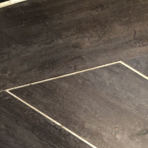 a wooden floor that has some kind of triangle on it, with the top half missing