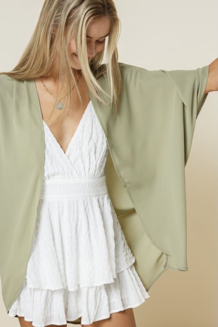 Light weight, silky smooth chiffon kimono. Creasing detail at shoulder. Perfect way to add a touch of color this spring & summer! Made in USA 100% Polyester Chic V-neck Summer Kimono, Elegant V-neck Kimono For Spring, Flowy V-neck Kimono For Day Out, Flowy Summer Blouse With Kimono Sleeves, Flowy Blouse With Kimono Sleeves For Summer, Elegant Faux Wrap Blouse For Spring, Elegant Spring Faux Wrap Blouse, Chic Beach Blouse With Kimono Sleeves, Chic Blouse With Kimono Sleeves For Beach