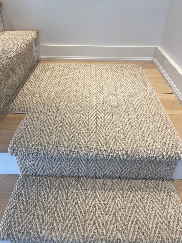 a carpeted stair case in an empty room