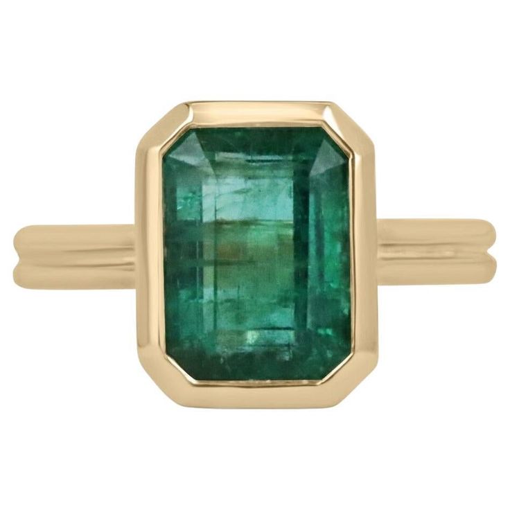 Displayed is a stunning emerald solitaire engagement or right-hand ring in 14K yellow gold. This gorgeous solitaire ring carries an estimated 4.45-carat emerald in a bezel setting. Fully faceted, this gemstone showcases excellent shine and beautiful, dark green color. The emerald has very good clarity with minor flaws that are normal in all genuine emeralds. An ideal solitaire, perfect for everyday use. Setting Style: Bezel Setting Material: 14K Yellow Gold Setting Weight: 6.0 Grams Main Stone: Luxury Solitaire Emerald Ring In Yellow Gold, Gia Certified Timeless Octagon Emerald Ring, Luxury Yellow Gold Emerald Solitaire Ring, Formal Octagon Solitaire Emerald Ring, Gia Certified Baguette Cut Emerald Ring In 14k Gold, Classic Gia Certified Emerald Ring, Timeless 14k Gold Baguette Cut Emerald Ring, Timeless Yellow Gold Emerald Ring With Center Stone, Heirloom Style Emerald Solitaire Ring