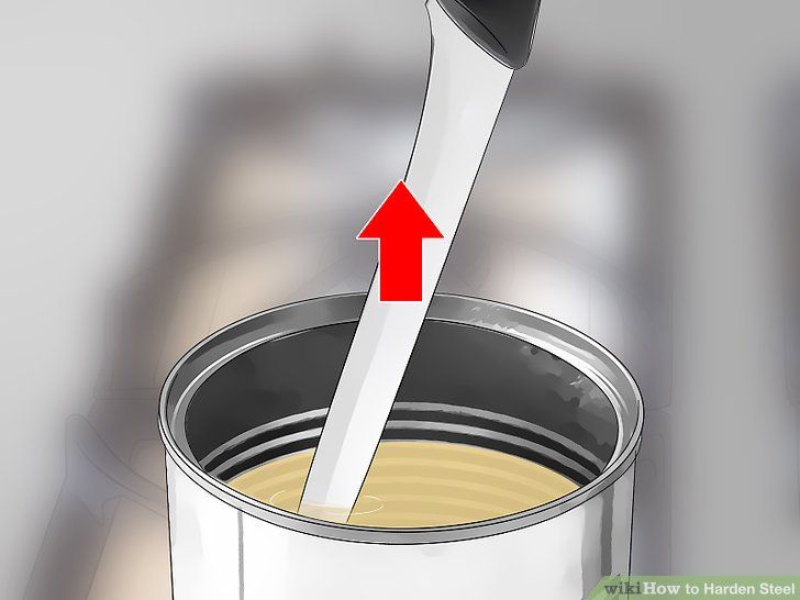 a white paint can with a red arrow sticking out of the top, and a black brush in it