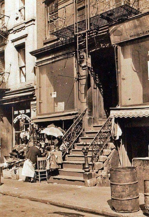 an old black and white photo of people on the street