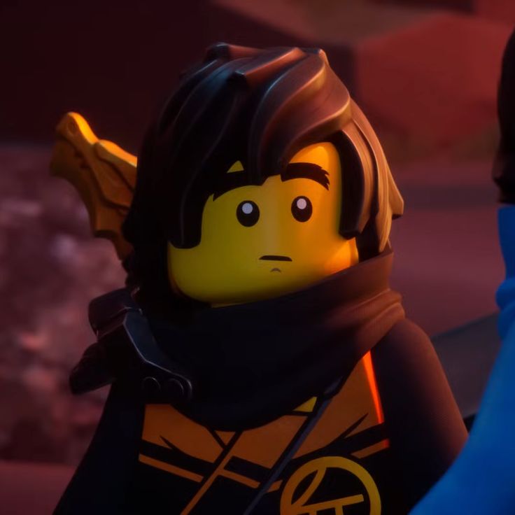 the lego movie character is wearing an orange and black outfit with a yellow light on his head