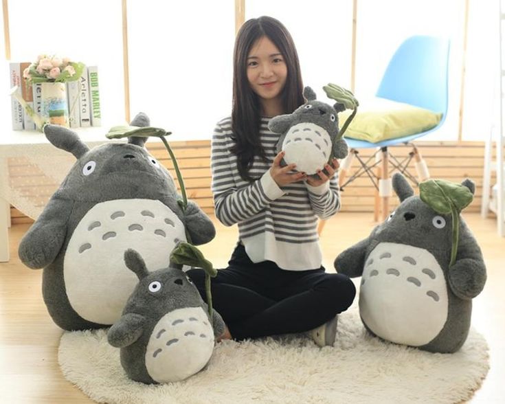 a woman sitting on the floor with stuffed animals