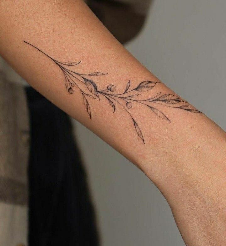 a woman's arm with a flower tattoo on the left side of her arm