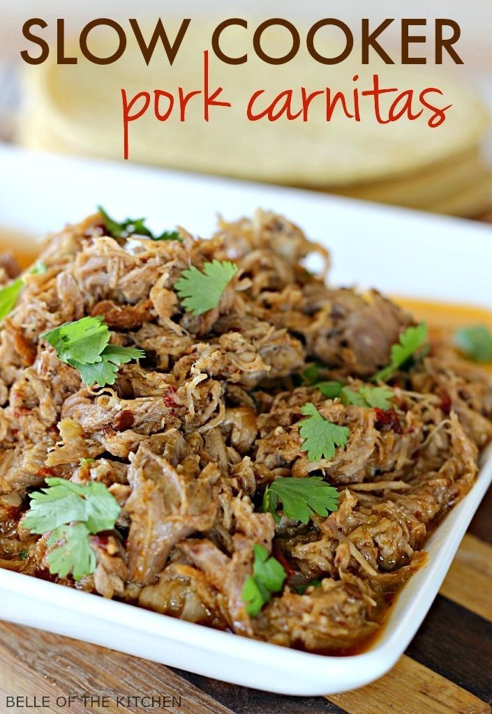 slow cooker pork carnitass on a plate with cilantro garnish