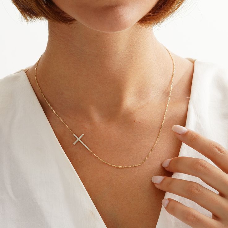 Your Sideways Cross Necklace is stylish, dainty and pretty ideal for everyday use. Details of solid gold handmade Custom Size Cross Jewelry are very eye-catching. It is a great gift for your loved ones. This jewelry will be an indispensable piece of yours. This meaningful Crucifix Jewelry with high quality handwork will be a legacy you can leave to your family its. * Details * Material / Gold Kt : This elegant necklace is made of 14k and 18k Solid Gold * Available Gold Colors : Yellow Gold, Whit Elegant Yellow Gold Cross Necklace, Elegant Everyday Yellow Gold Cross Necklace, 14k Gold White Diamond Necklace With Clavicle Chain, White 14k Gold Diamond Necklace With Clavicle Chain, White Diamond Necklace With 14k Gold Clavicle Chain, 14k Gold Chain Necklace With Diamond Accents As Gift, Dainty Cross Jewelry In Cubic Zirconia, Dainty Cross Necklace In Cubic Zirconia, Dainty Cross-shaped Cubic Zirconia Jewelry