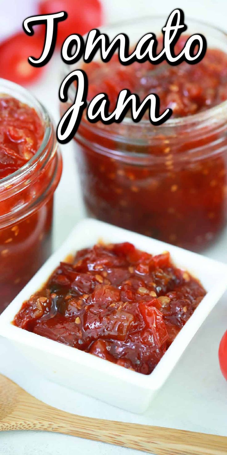 tomato jam in small glass jars on a cutting board