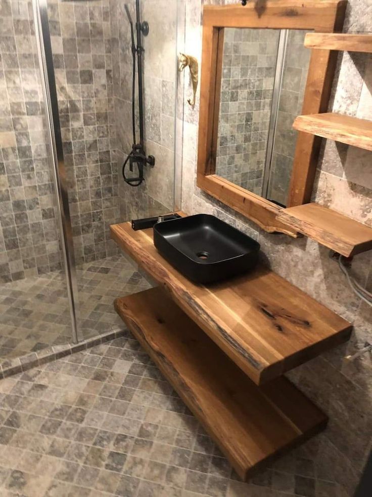 a bathroom with a stand up shower and wooden bench in the middle of the floor