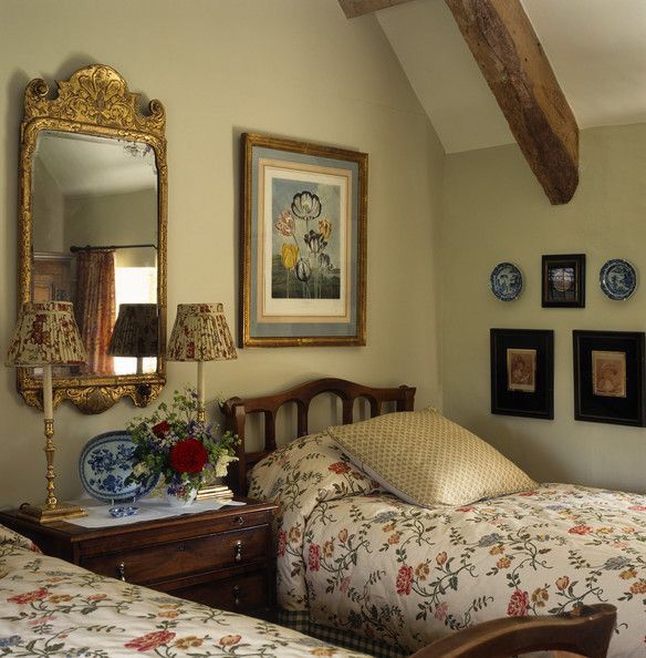 two beds in a room with pictures on the wall