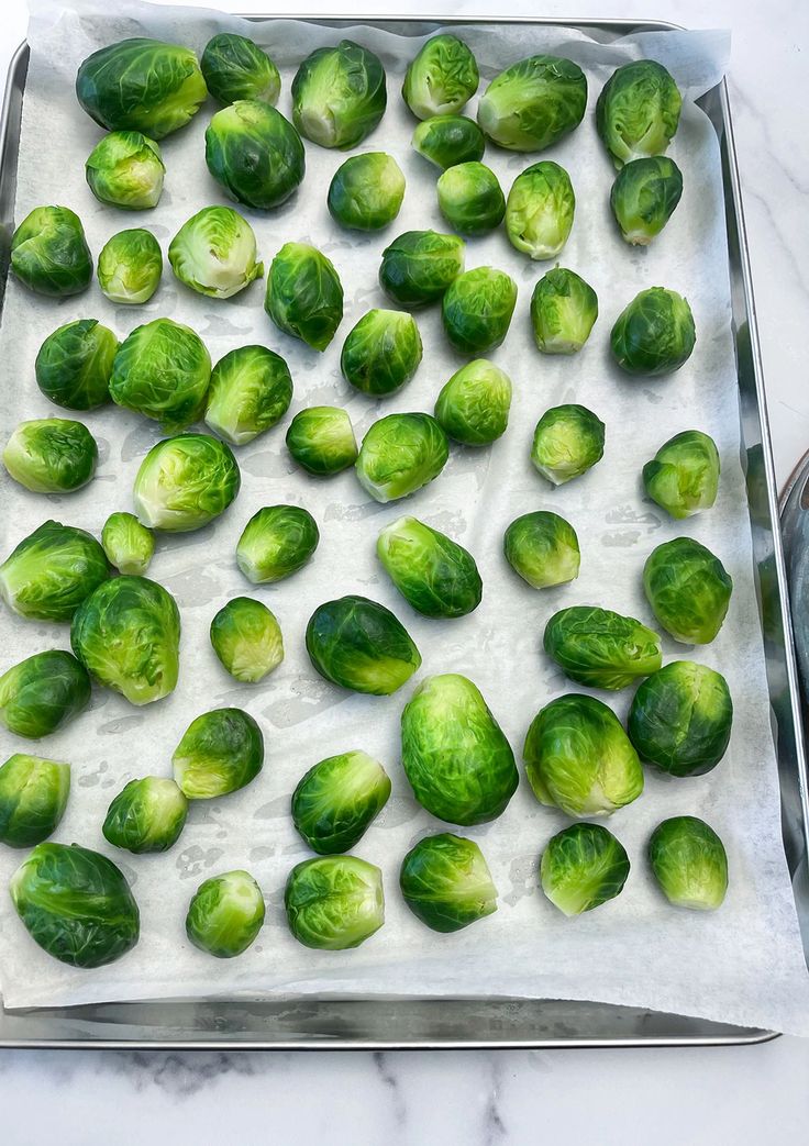 brussel sprouts on a baking sheet ready to be cooked in the oven