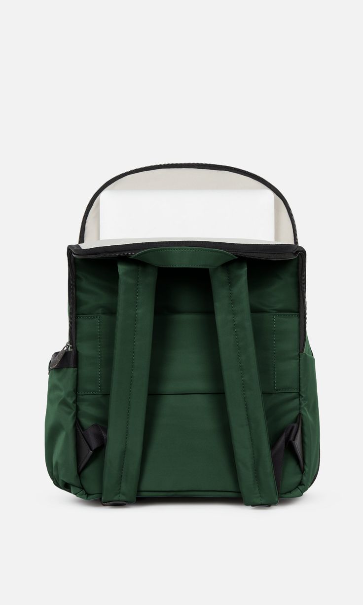 Our classic Chelsea Daypack has been reimagined with extra space. This smart, streamlined backpack has plenty of handy features: a back sleeve that slots over a suitcase handle, a full zip opener for easy packing and access, a zipped front pocket with card sleeve and key clip inside, a 16.5” laptop pocket, and an elasticated side pocket for a water bottle. The zipped, padded laptop pocket has an additional slip pocket for a tablet. Inside the backpack, there’s a removable packing pocket for shoe Modern Green Nylon Backpack, Modern Green Backpack With Zipper Closure, Small Rucksack, Suitcase Handle, Green Travel, Easy Packing, Card Sleeve, Key Clip, Laptop Pocket