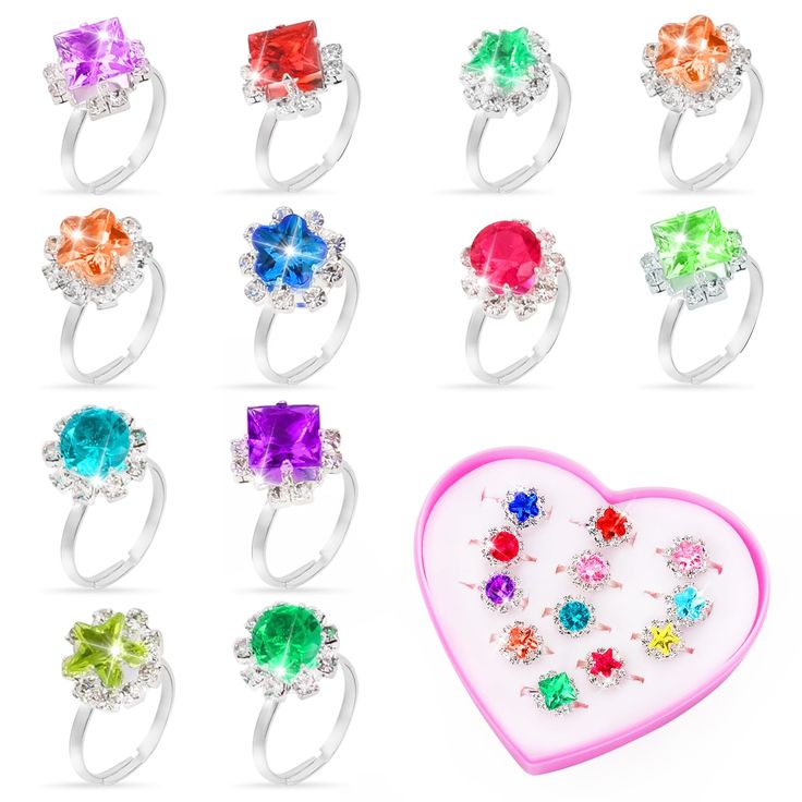 an assortment of rings with different colors and shapes on them, including one heart shaped ring