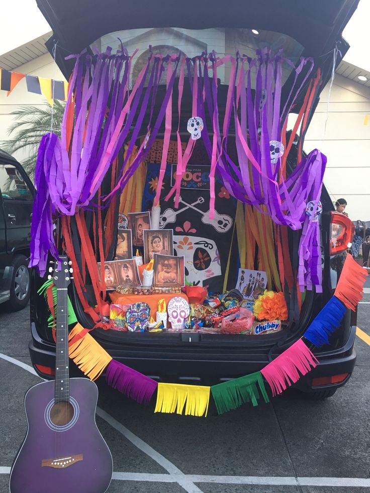 the back of a car decorated for halloween with decorations and music instruments on it's trunk