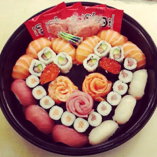 sushi in a black bowl on a table