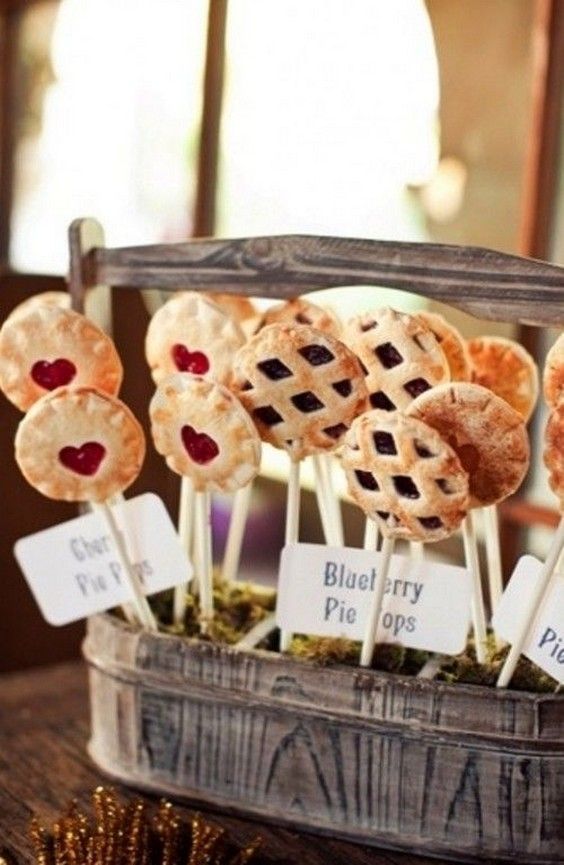 some pies are on sticks with blueberry toppings