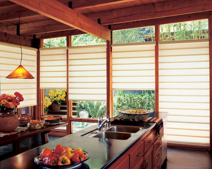 an image of a kitchen setting with blinds in the window and fruit on the counter