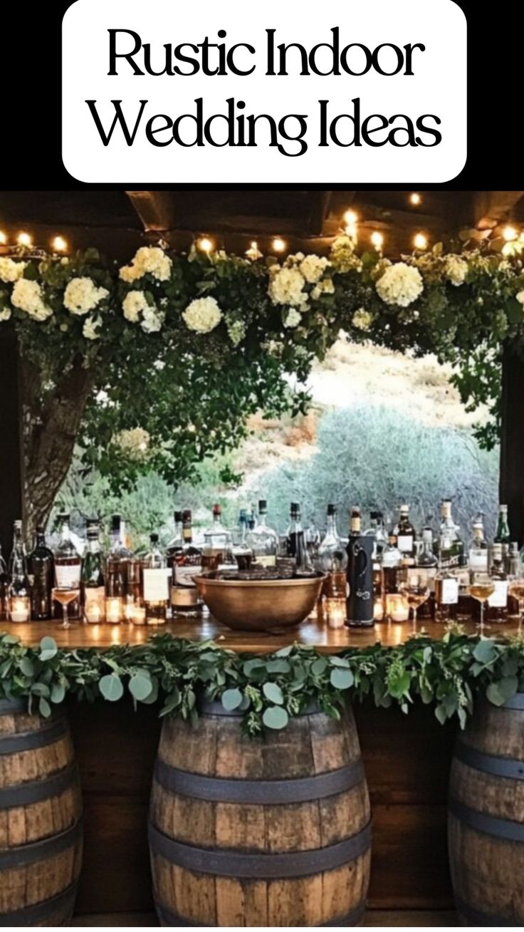 Elegant rustic wedding reception with wooden barrel tables decorated with greenery and candles indoors. Rustic Inside Wedding, Rustic Cocktail Wedding Reception, Rustic Micro Wedding, Cabin Reception Wedding, Simple Wedding Decorations Indoor, Fall Barn Wedding Ideas, Indoor Rustic Wedding, Vineyard Reception, Elegant Rustic Wedding Ideas