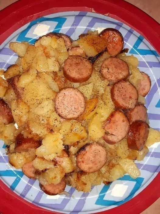 a plate with some sausage and potatoes on it