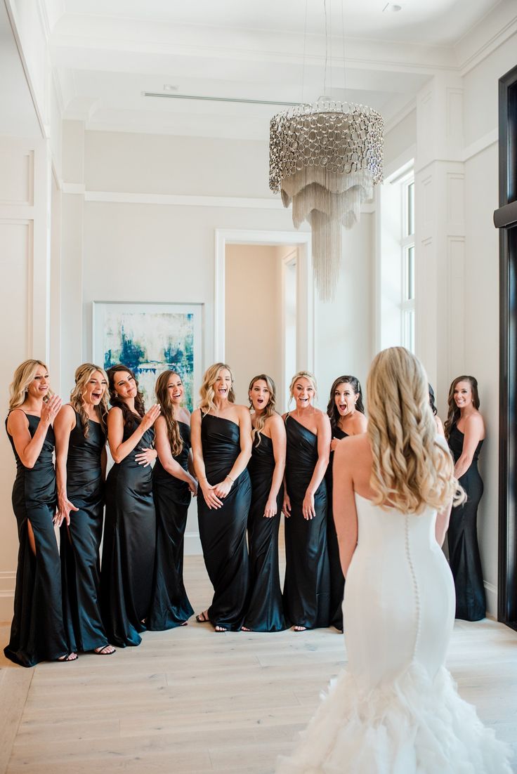 a bride and her bridal party in black gowns at the four seasons hotel