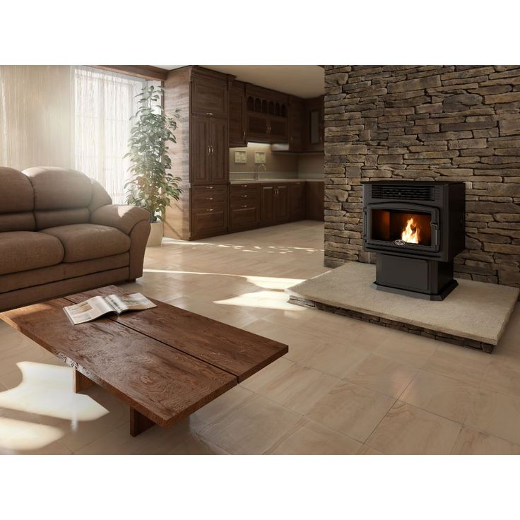 a living room filled with furniture and a fire place in the middle of it's walls