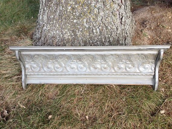 a white bench sitting next to a tree in front of a large gray oak tree